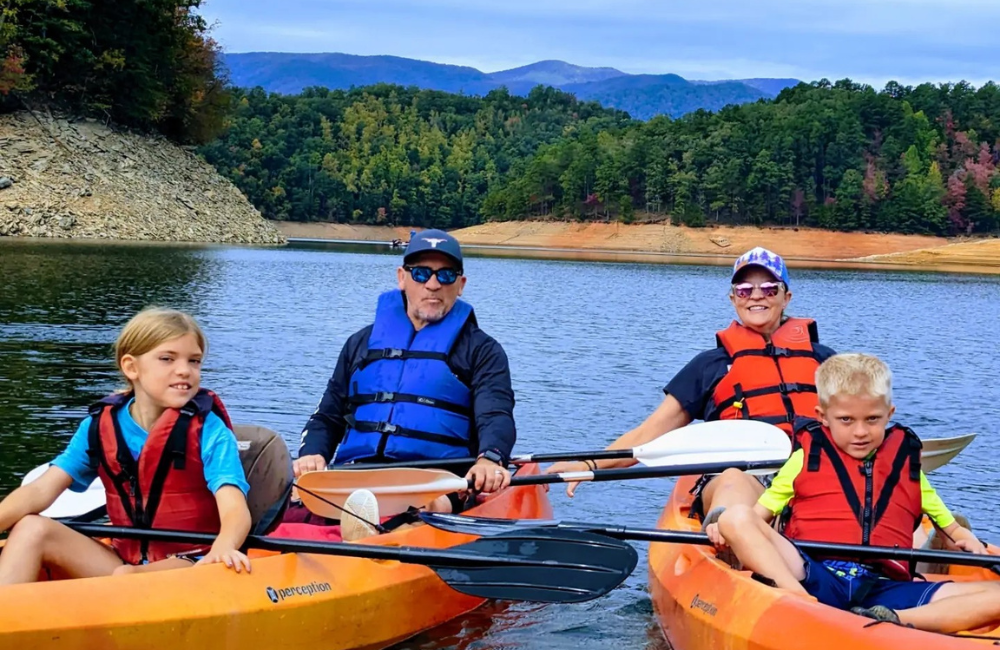 family kayaking on a lake near Bryson City NC