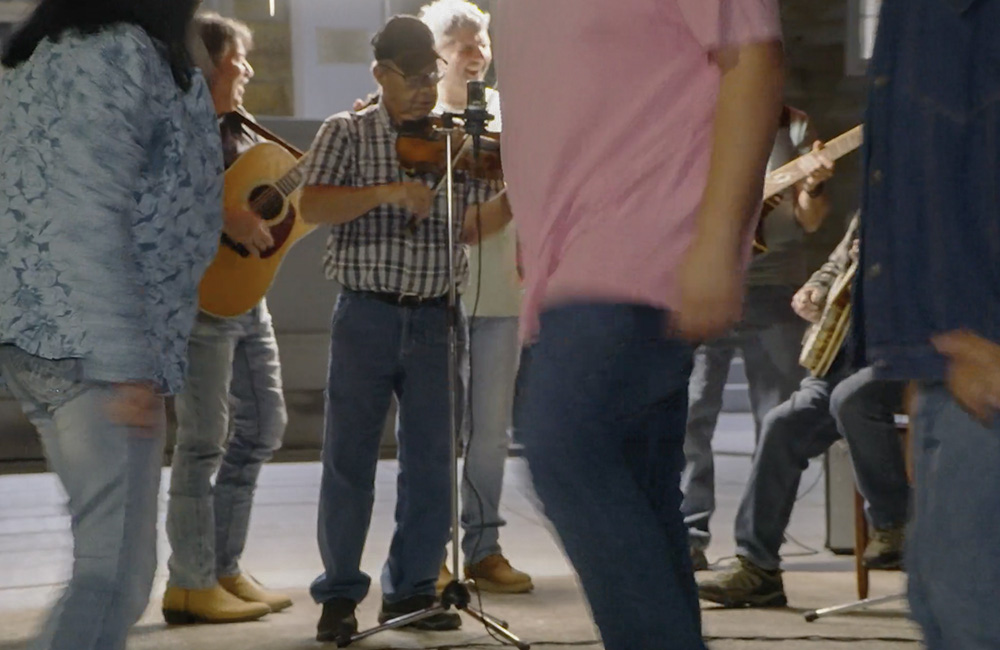 Fiddler at dusk Dancing on the Square, Robbinsville