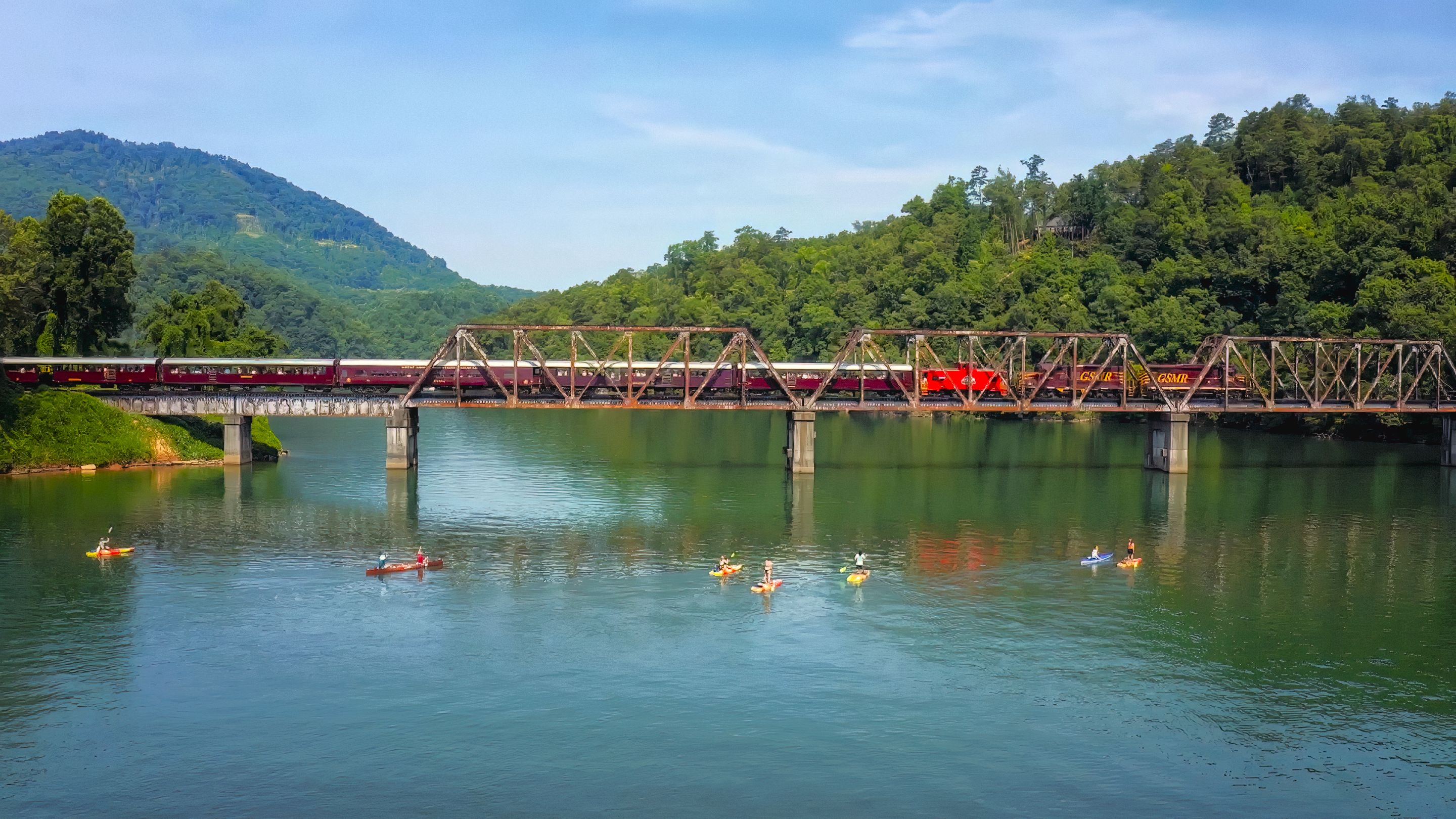 paddleboarding under a train trestle in Bryson City NC