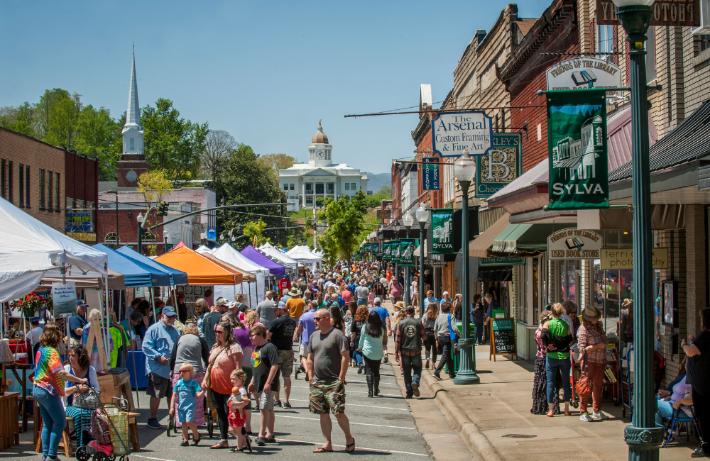 People on the street and mountains in the background of downtown Sylva