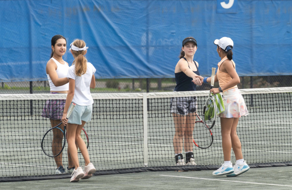 Junior tennis players shake hands