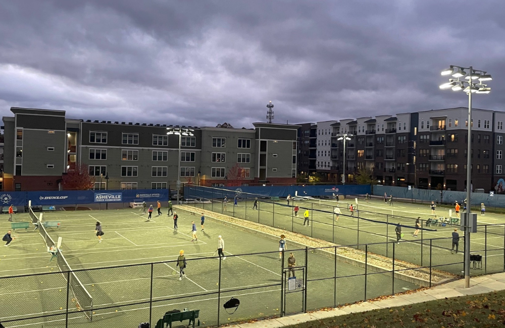 Tennis players on the court in the evening