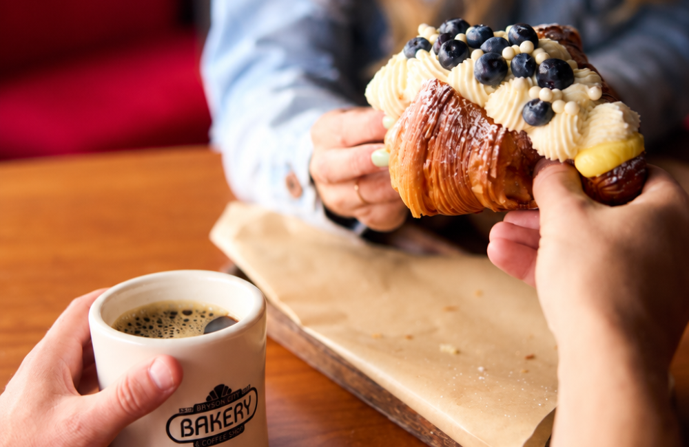 Sharing a fruit covered baked treat and coffee at Bryson Bakery in Bryson City NC