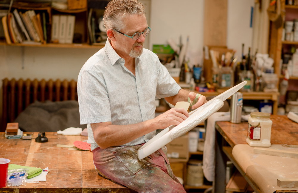 artist at work on a canvas