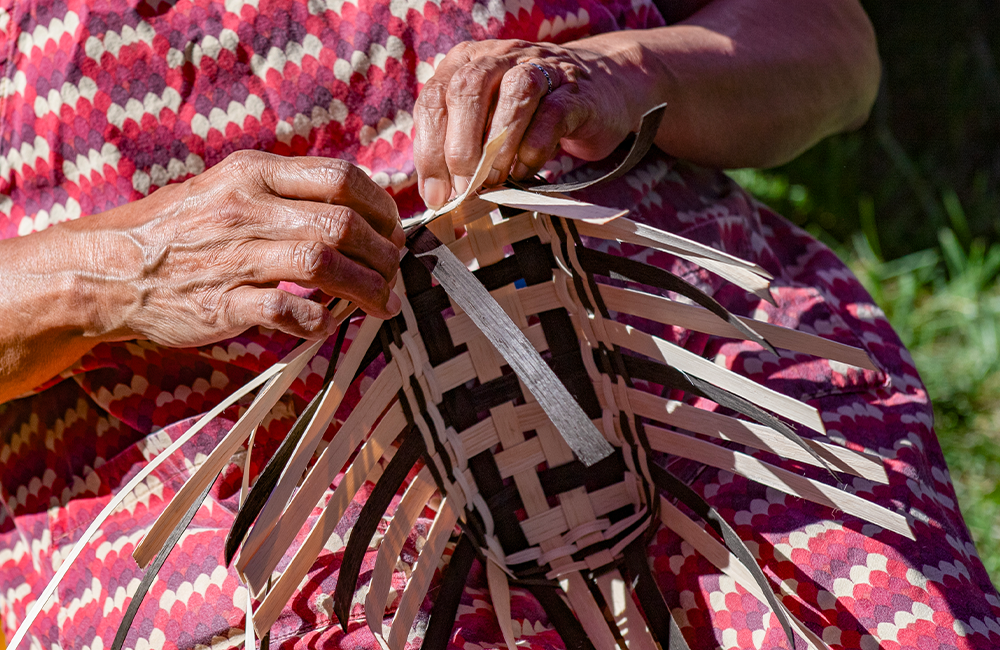 Woman weaving a basket