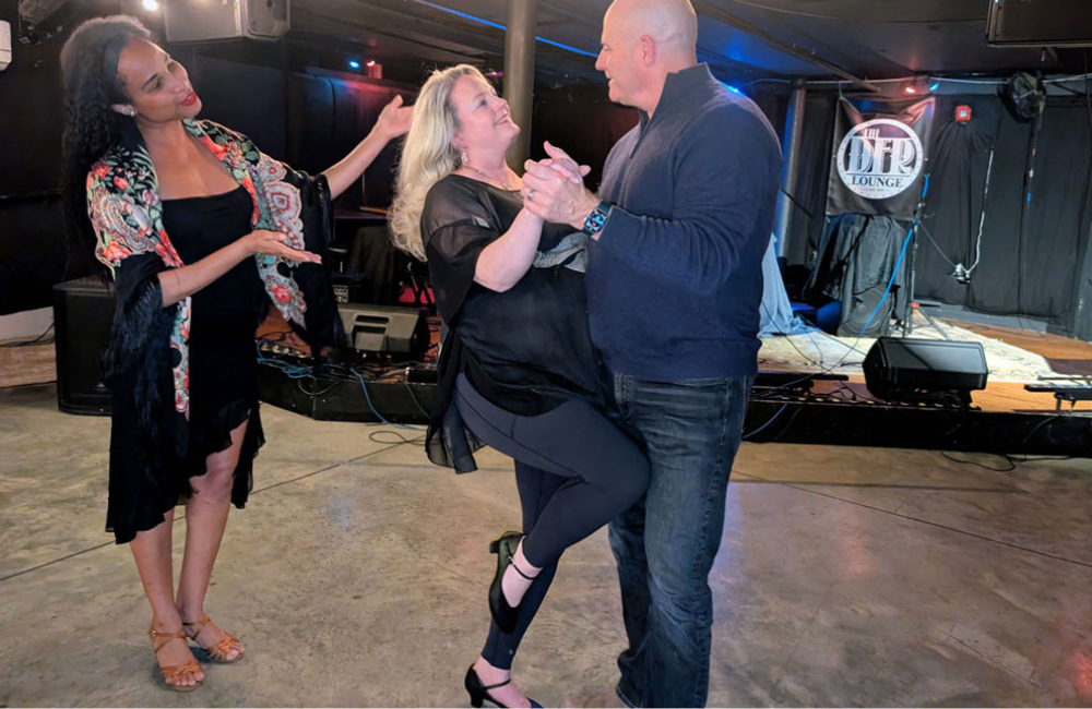 A dance instructor with Audancity in Brevard NC guides a dancing couple