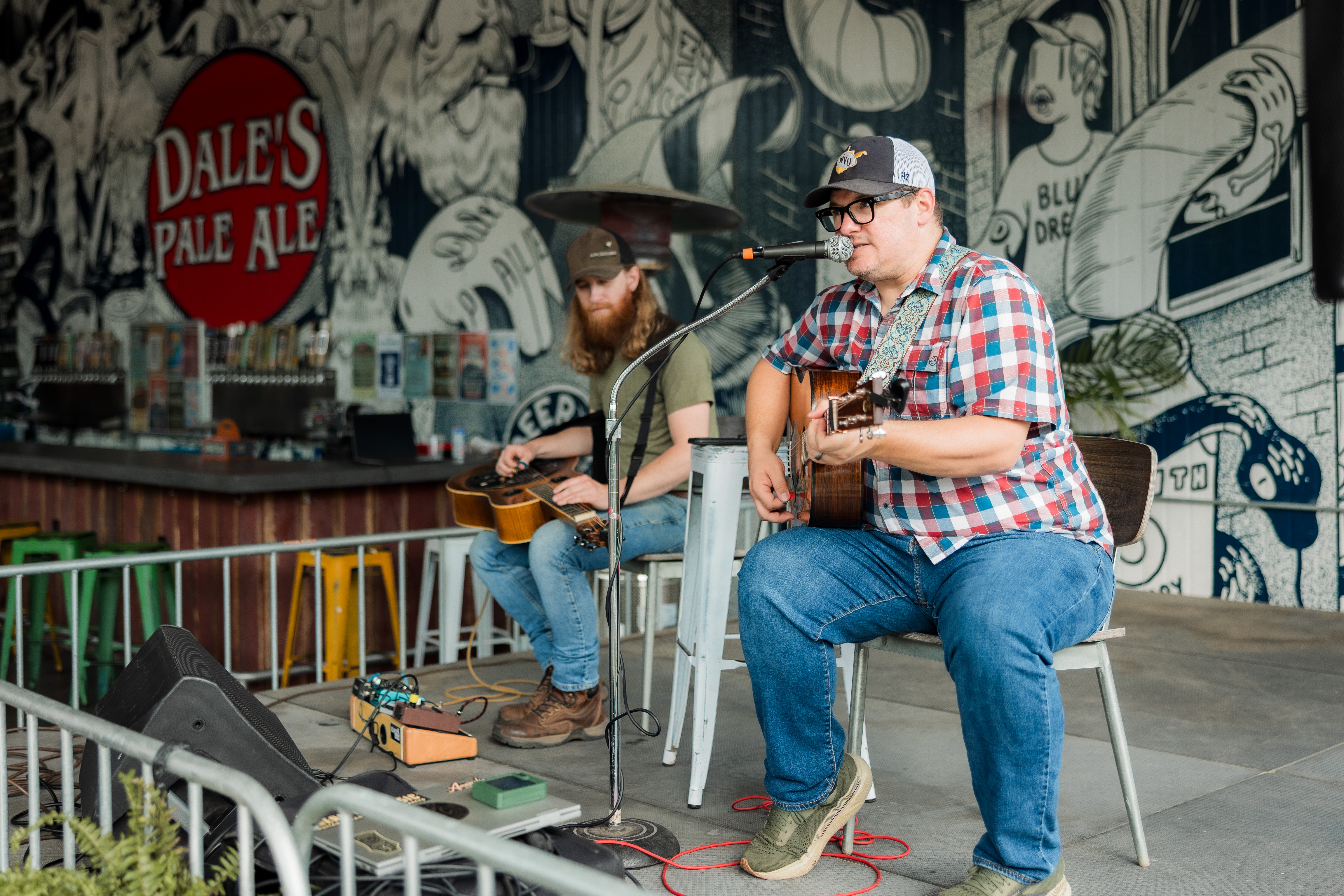 A band performing on the stage at Oscar Blues Brewing