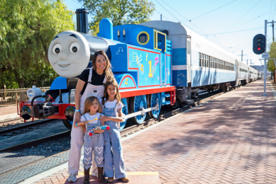 Family posing in front of Thomas the Tank Engine