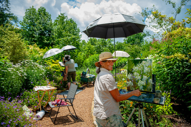 Cashiers Plein Air Festival Artist smiling while painting during Cashiers Plein Air Festival