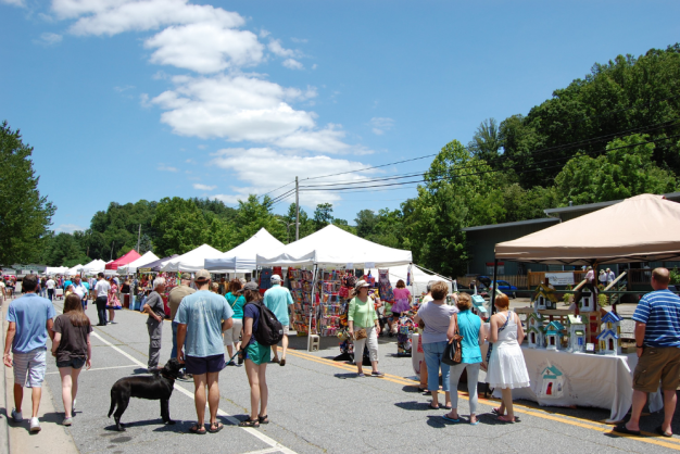 People enjoying a street festival under blue skies