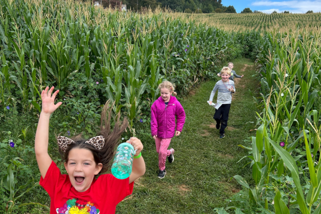 Asheville Eliada Corn Maze Children happily running through a corn maze